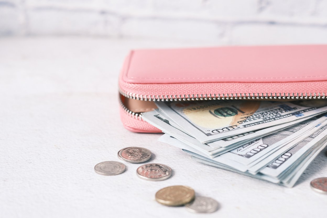 100 Dollar Cash in Leather on Pink Background